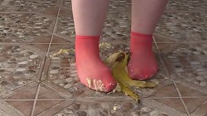 Fat legs in socks ruthlessly trample banana. crush fetish, foot fetish.
