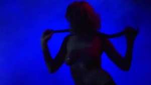 Fetish striptease on public stage