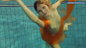 Yellow and Red clothed teen underwater
